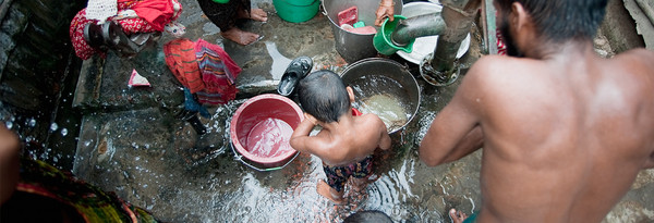 People filling buckets with water